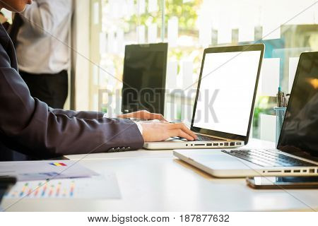 Two businessmen looking at report and having a discussion in office. business concept.