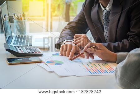 Two businessmen looking at report and having a discussion in office. business concept.