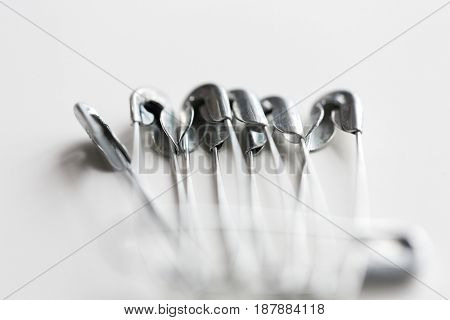 needlework and tailoring concept - sewing pins