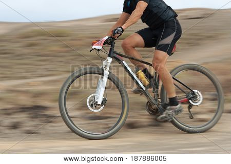 Motion blur of a mountain bike race with the bicycle and rider at high speed