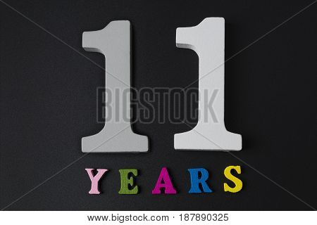 Letters And Numbers Eleven Years On The Black Background.