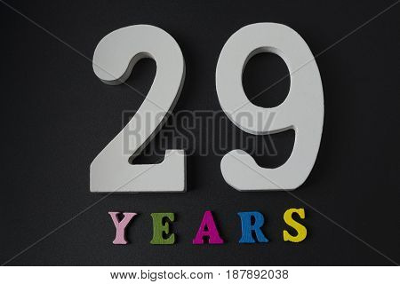 Letters And Numbers Twenty-nine Years On A Black Background.