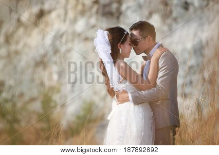 Asian couples photos of pre wedding concept of love and Marriage in nature outdoor on rocky mountain background.