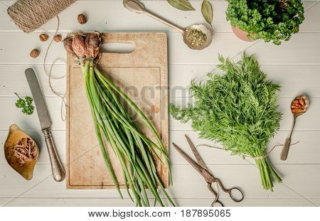 Green onion, dill on the cutting board, topshot