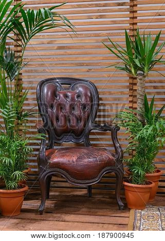 antique leather chair on a wooden veranda