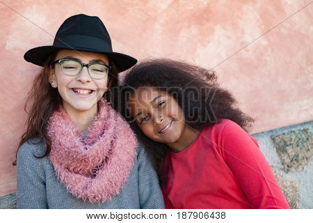 Two happy girls friends with stylish hats lauging 