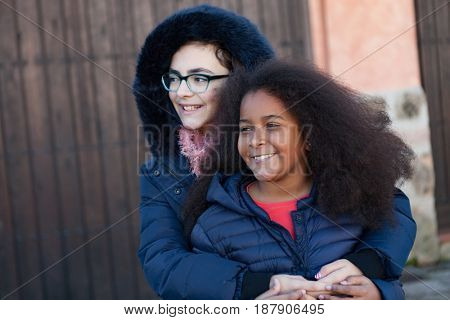 Two happy girls friends lauging outside