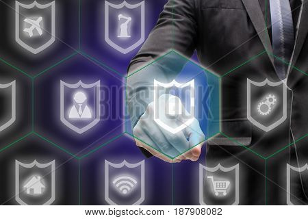internet of things business and technology internet and networking concept-business man point hand to the shield which protect and secure the data or information the shield will reject the data which harmful