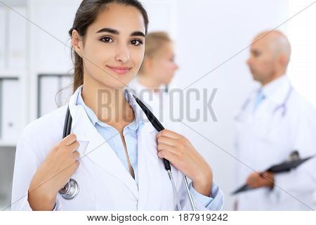 Happy doctor woman with medical staff at the hospital.