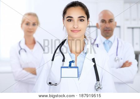 Happy doctor woman with medical staff at the hospital.