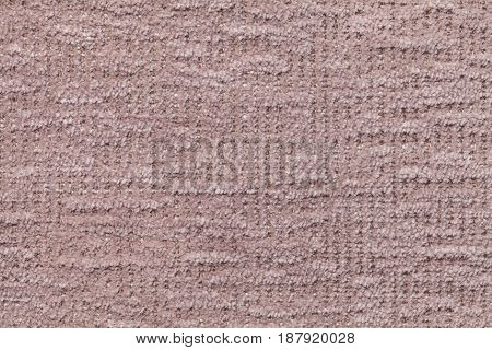 Light brown fluffy background of soft fleecy cloth. Texture of taupe plush furry textile closeup.