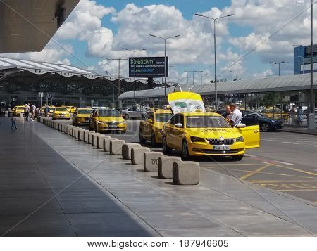 PRAGUE CZECH REPUBLIC - CIRCA JULY 2016: row of yellow taxis waiting for costumers in front of the airport
