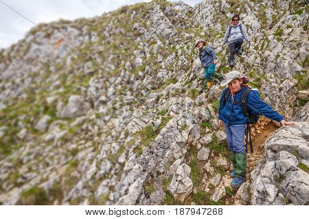 Family hiking mother and kids on mountain trek