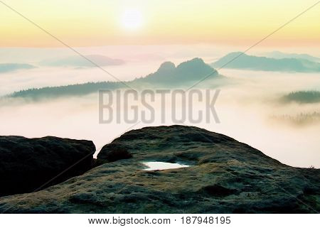 Dreamy Misty Landscape. Majestic Mountain Cut The Lighting Mist. Deep Valley Is Full Of Colorful Fog