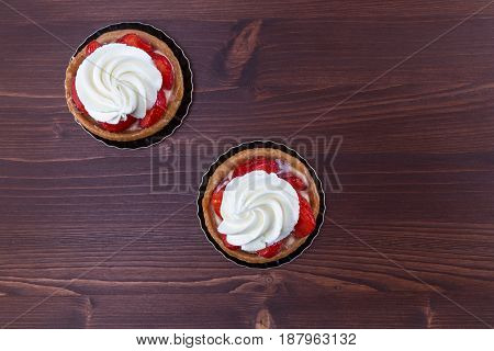 Two Delicious Strawberry Tarts With Chantilly Cream - Tartellete - On An Ipe Natural Wood Table - To