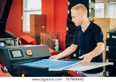 Young Man Working In Printing Factory