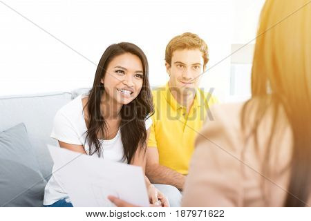 Young interracial couple meeting with consultant (or counselor financial adviser real estate agent etc.)