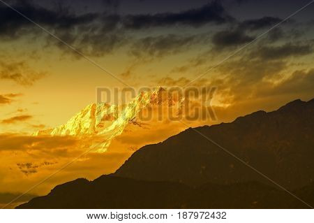 Beautiful last light from sunset on Mount Kanchenjugha Himalayan mountain range Sikkim India. color tint on the mountains at dusk