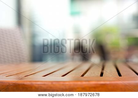 Empty round wood table top in outdoor cafe - can be used for display or mintage your products