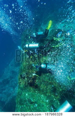 Group Of Divers Going Deep