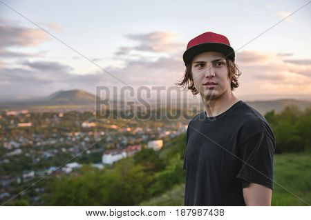 A large portrait of a young skater at sunset mok-up