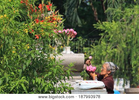 HO CHI MINH CITY VIETNAM - NOVEMBER 28, 2016: Unidentified woman prays at Vinh Nghiem pagoda temple Ho Chi Minh City Saigon Vietnam