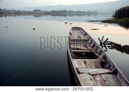 The Wooden Boat Was Resting In The River Calmly.