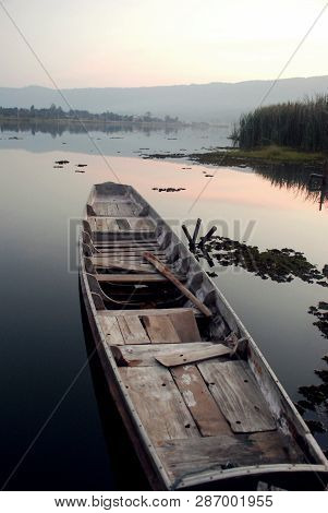 The Wooden Boat Was Resting In The River Calmly.