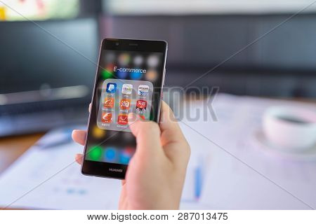 Chiang Mai, Thailand - May 05,2018: Man Holding Huawei With Icons Of E-commerce And Online Shopping 