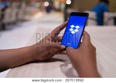 Chiang Mai, Thailand - April 4,2018: Man Holding Huawei With Dropbox On Screen. Dropbox Is A Service