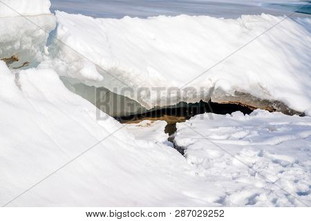 Blocks Of Ice Melt In The Spring On The Shore Of The Pond