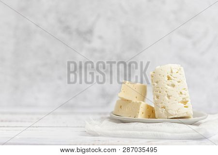 Sliced Feta Cheese On Light Background. High Key. With Copy Space.