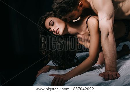 Beautiful Sexy Half-naked Couple In Bed Isolated On Black With Copy Space
