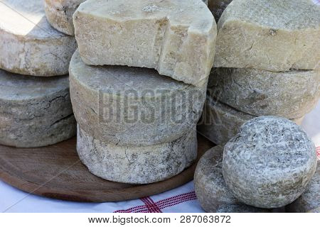 Various Varieties Of Popular Georgian Cheese, Located On The Street On A Sunny Day On A Table . Chee