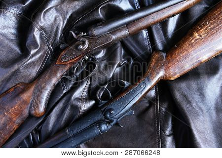 Pair Of Ancient Hunting Shotguns Closeup On Leather Background