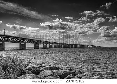 Oresundsbron From Rocky Beach In Black And White