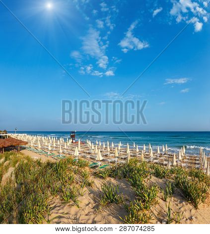 Sunshiny Paradise White Sandy Beach With Sunshades And Sunbeds (salento, Puglia, South Italy). The M
