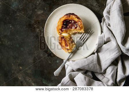 Traditional Portuguese Egg Tart Dessert Pasteis Pastel De Nata On Ceramic Plate With Fork And Cloth 