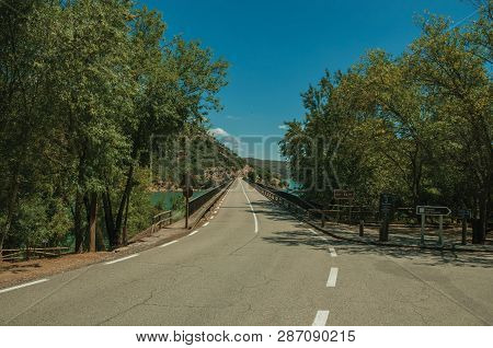Monfrague. July 04, 2018. Road And Bridge Over The Tagus River On Sunny Day At The Monfrague Nationa