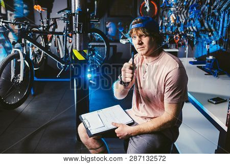 Young Handsome Stylish Man In A Cap Snapback And With A Tattoo Small Business Owner Selling A Bicycl