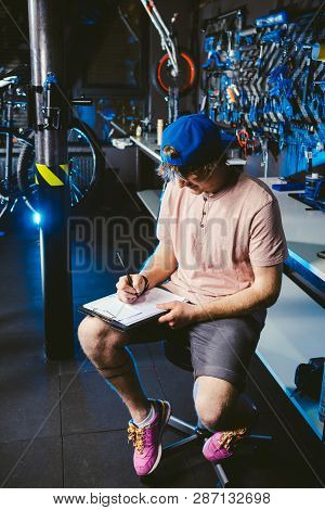 Young Handsome Stylish Man In A Cap Snapback And With A Tattoo Small Business Owner Selling A Bicycl