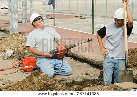 Construction workers sharing a lighthearted moment while working.