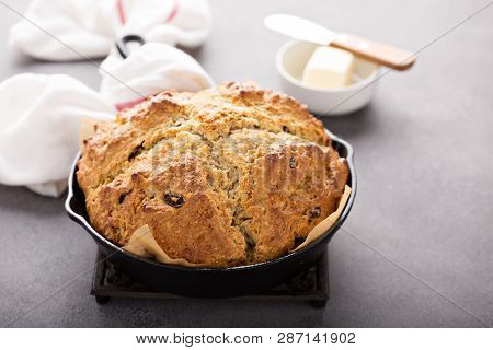 Traditional Soda Bread With Raisins Baked In A Cast Iron Pan