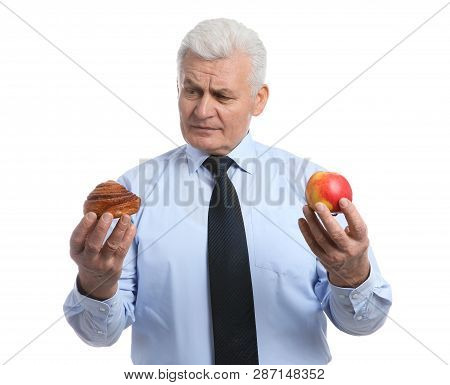 Senior Man With Pastry And Apple On White Background. Diabetes Diet