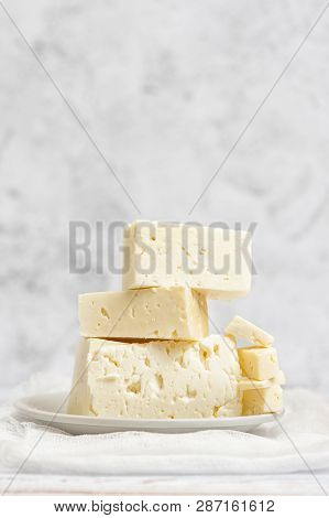 Sliced Feta Cheese On Light Background. High Key. With Copy Space.