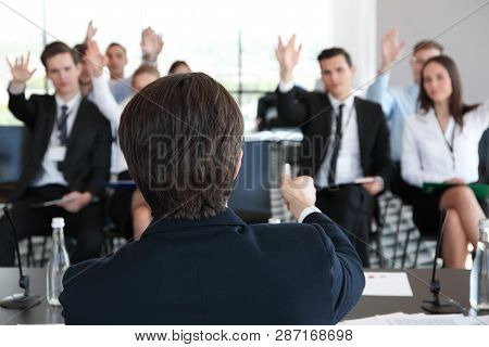 Speaker At Business Conference And Audience Answering Questions