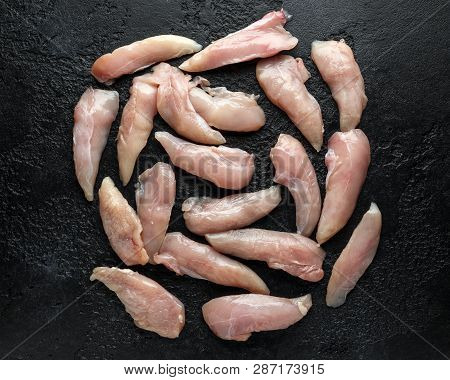 Raw Chicken Breast Mini Fillets In Rastic Cast Iron Skillet, Frying Pan With Herbs And Sea Salt
