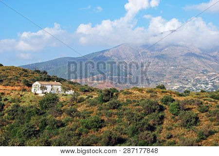 View Across Countryside Towards The Sierra De Mijas Mountains With A Traditional Spanish Finca In Th