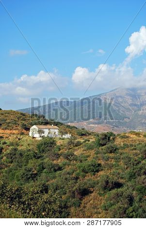View Across Countryside Towards The Sierra De Mijas Mountains With A Traditional Spanish Finca In Th