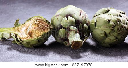 Artichokes On Rustic Background. Fresh Organic Artichoke Flower Set